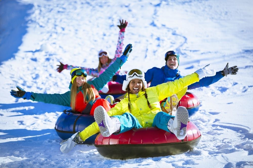 Happy People On A Snow Tube Outdoors 9E74878B