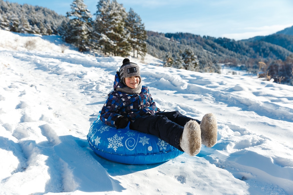 Child Enjoying Snow Tubing Ride