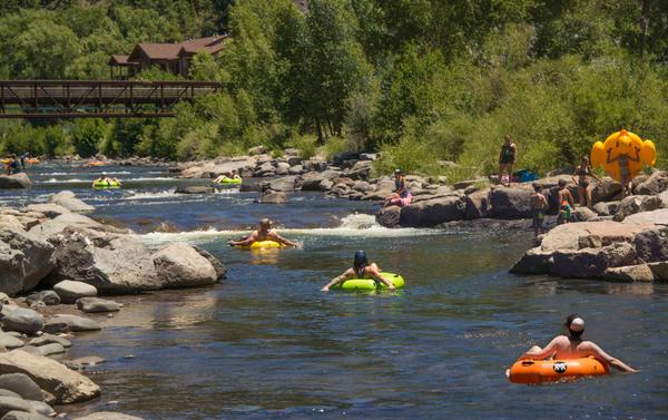 Families Having Fun Floating Inflatable Tubes Hot Summer