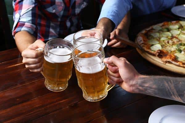 10 Best Bars To Visit In Gatlinburg, Tn 2 Male Hands Holding Glasses With Beer And Pizza