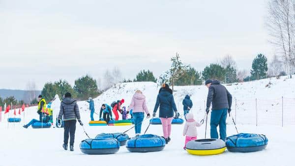 People Riding Snow Tubing