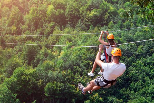 Tourists Ride On The Zipline